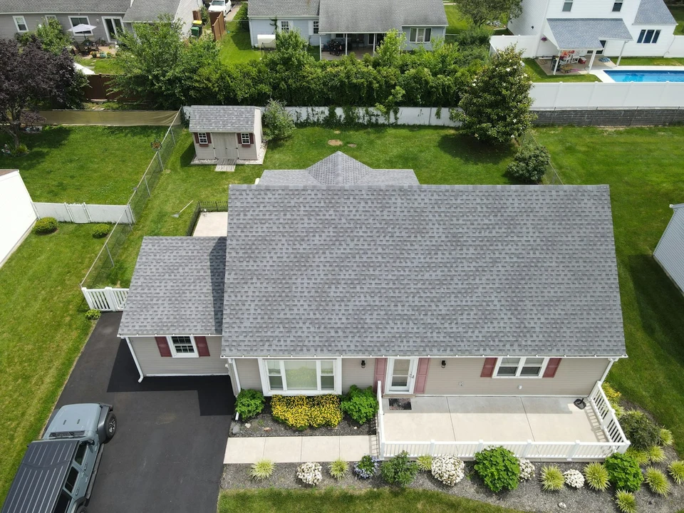 Residential house with a newly installed grey architectural-shingle roof